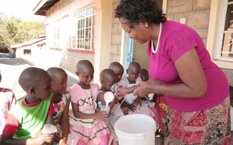 about-charles-3 Esther Mully pouring milk