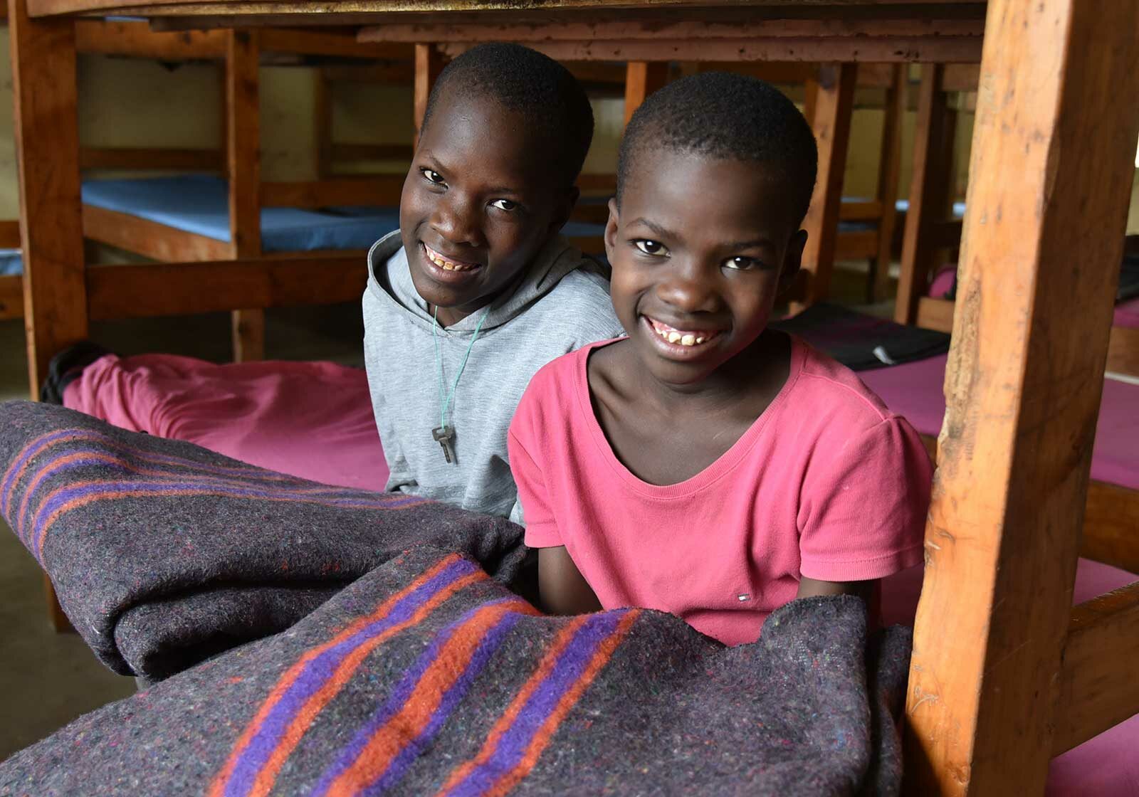 photo: girls sitting with blankets in dormitory